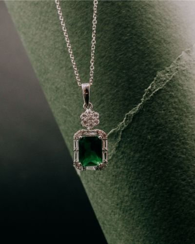 Emerald drop pendant on silver chain