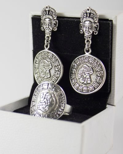 Silver drop earrings with engraved medallion charms, paired with a matching ring, in a gift box