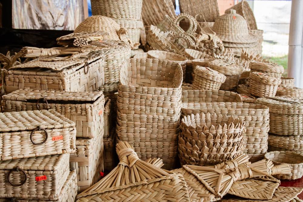 Hand-woven cane baskets stacked in an artisan workshop